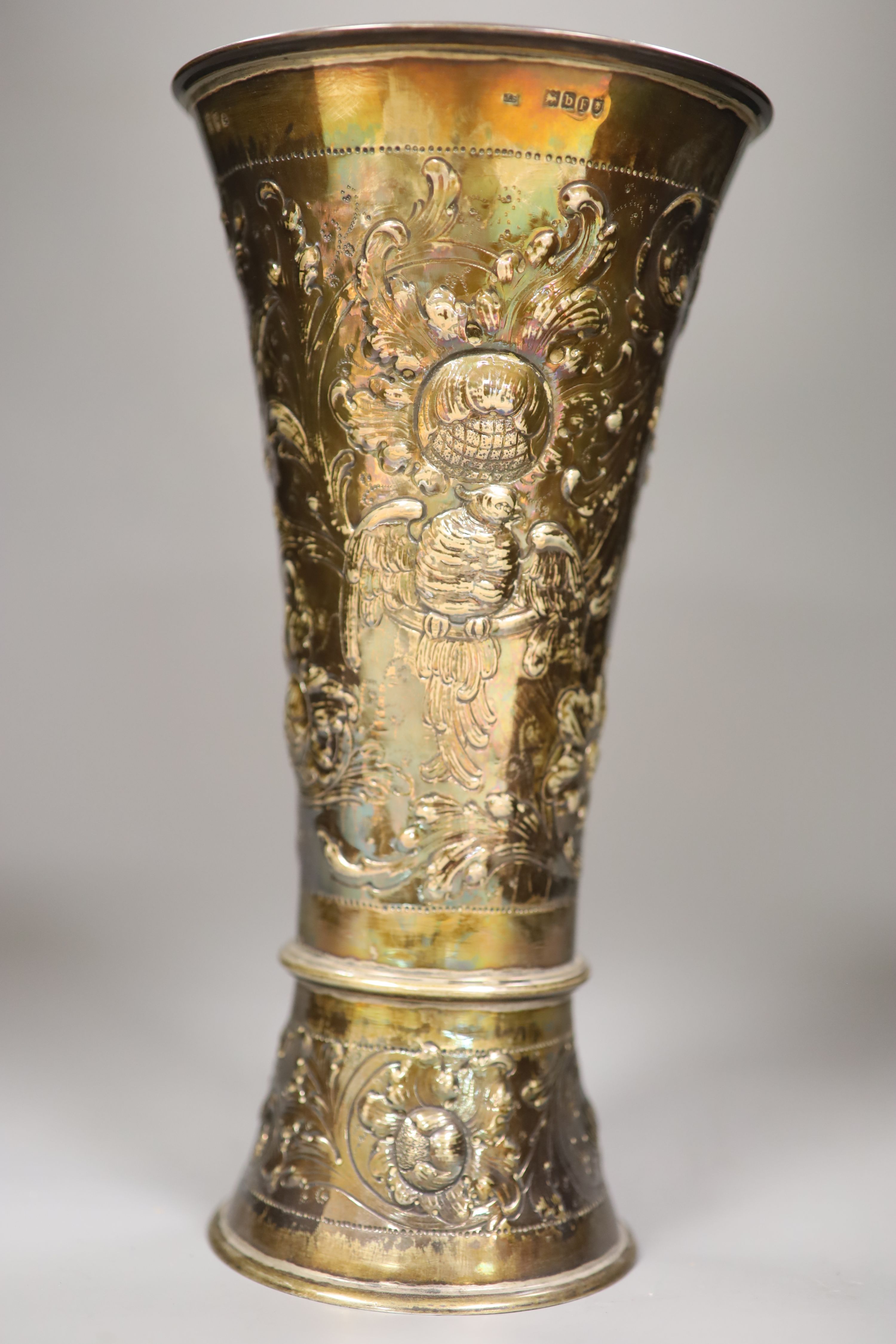 A late 19th century Hanau embossed white metal vase with, London 1897 import mark, decorated with birds and flowers,